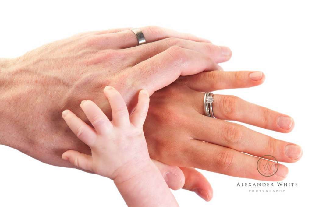 Baby Thomas' hand holding onto his parents