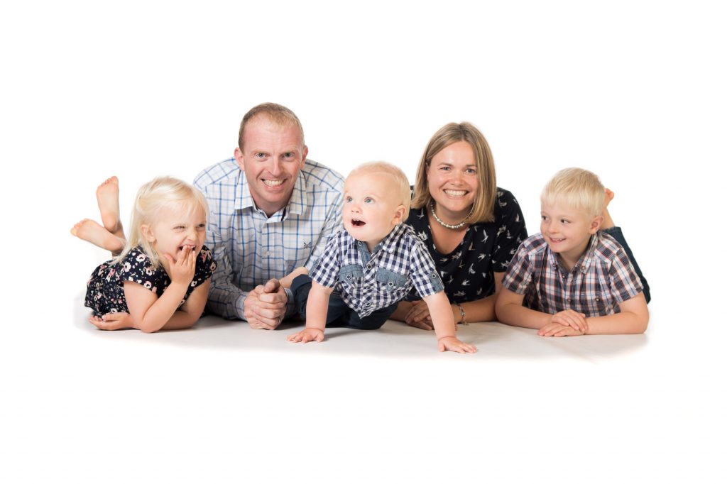 Family photograph of a family with three young kids