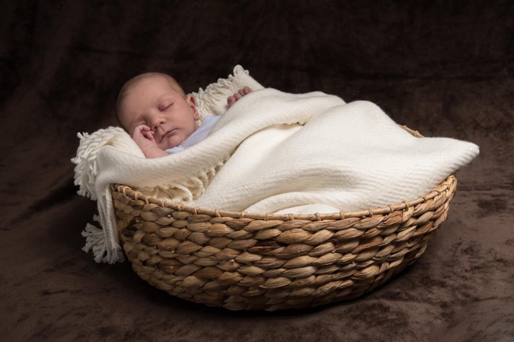 A baby asleep in a basket