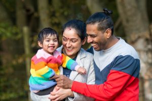 Mother father and baby photo on an outdoor family photo shoot