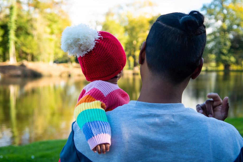 Father and baby looking out over a pond