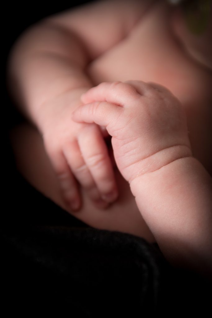 Close up detail photo of a newborn baby's hands