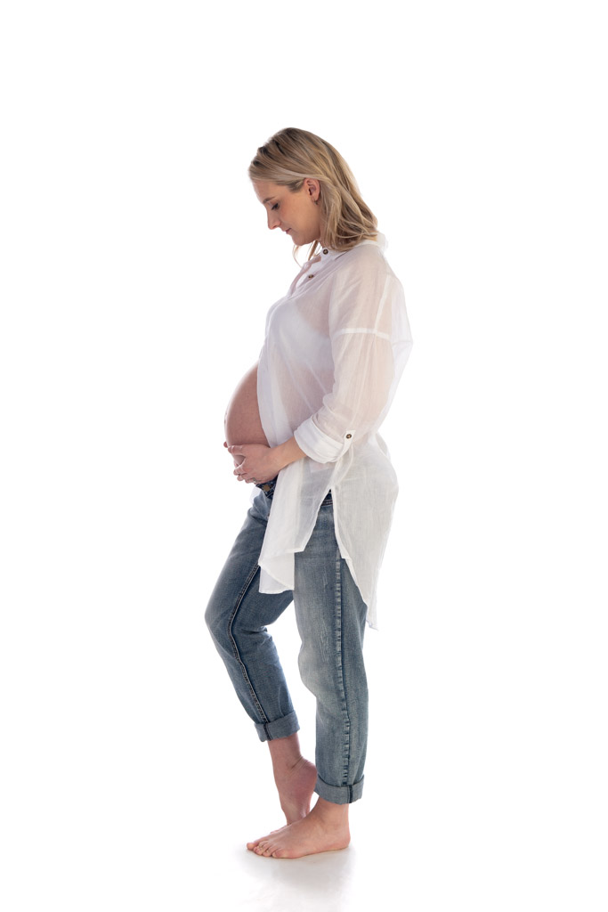 Maternity Photo of an expectant/pregnant mother looking down at her baby bump