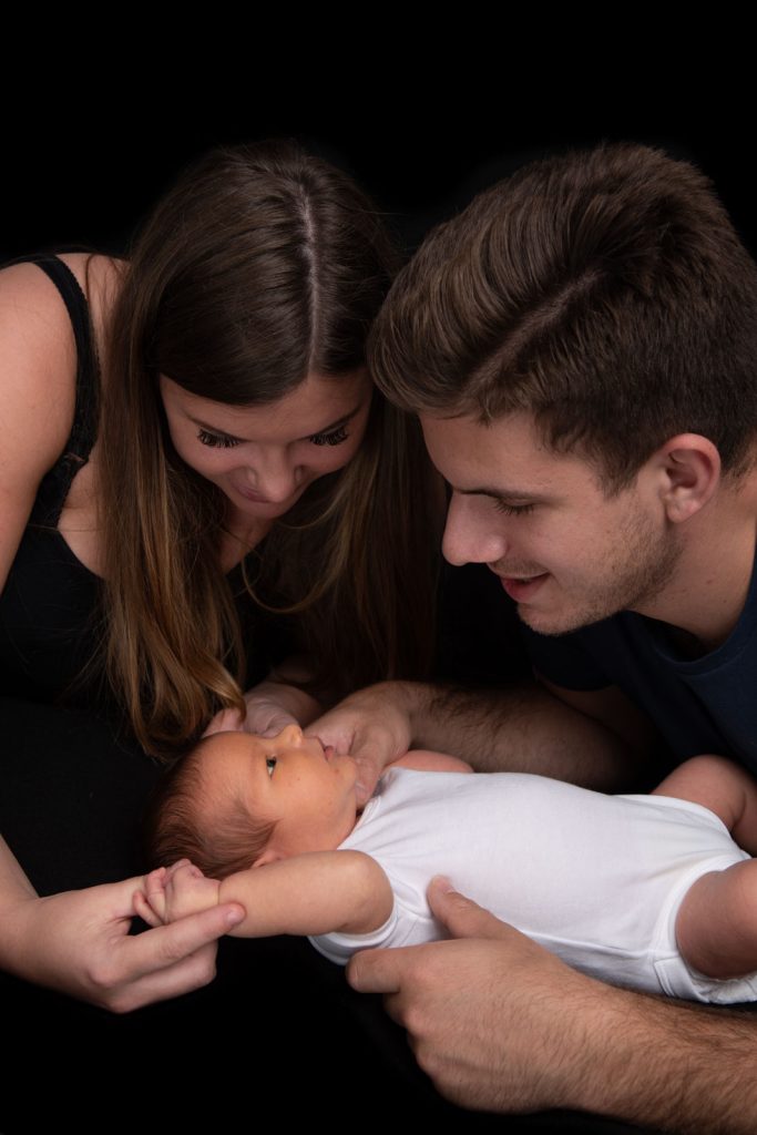 Parents showing off their newborn baby
