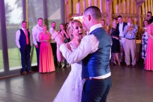 wedding photo of a bride and groom enjoying their first dance