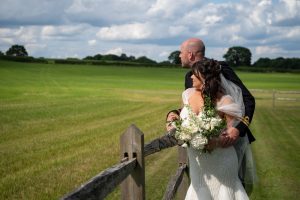 wedding photo of the bride and groom looking out over a field
