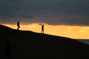 Photo of a couple walking downhill in silhouette