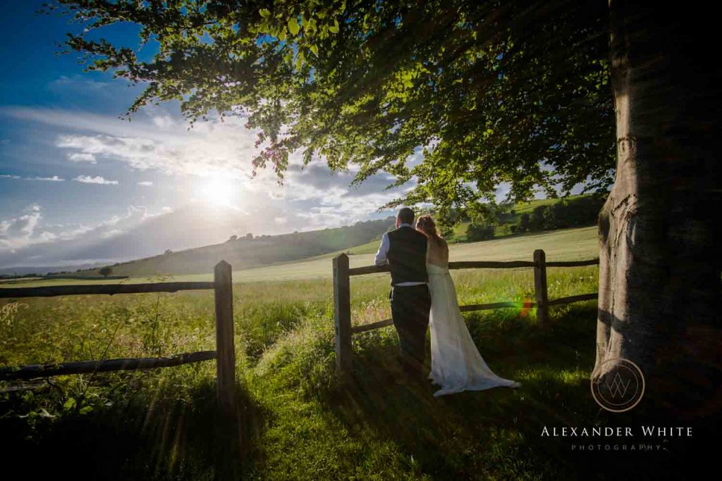 Wedding photo of couple looking out over the South Downs