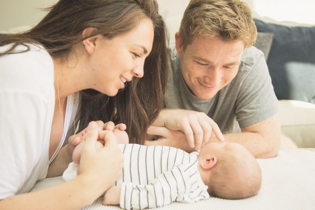 A young family photographed with their newborn son