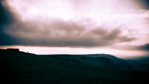 A wide shot of the scene, with Alex and Emily in the distance,, edited to make it more dramatic