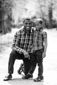 Father and son pose for a family photo