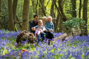 family photo in a bluebell wood