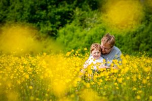 Father and son amongst wildflowers on a Wild Flower Meadow Photo Shoot