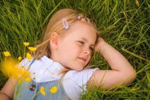 Young girl lying amongst wildflowers