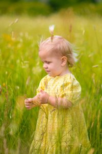 Young girl in a wildflower meadow on a family portrait photo shoot