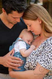 Young family showing off their baby for a family photo