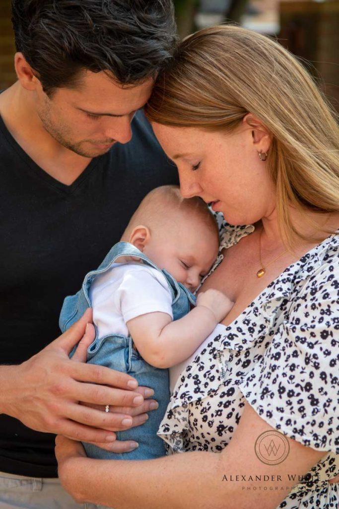 parents and newborn baby sleepy cuddle