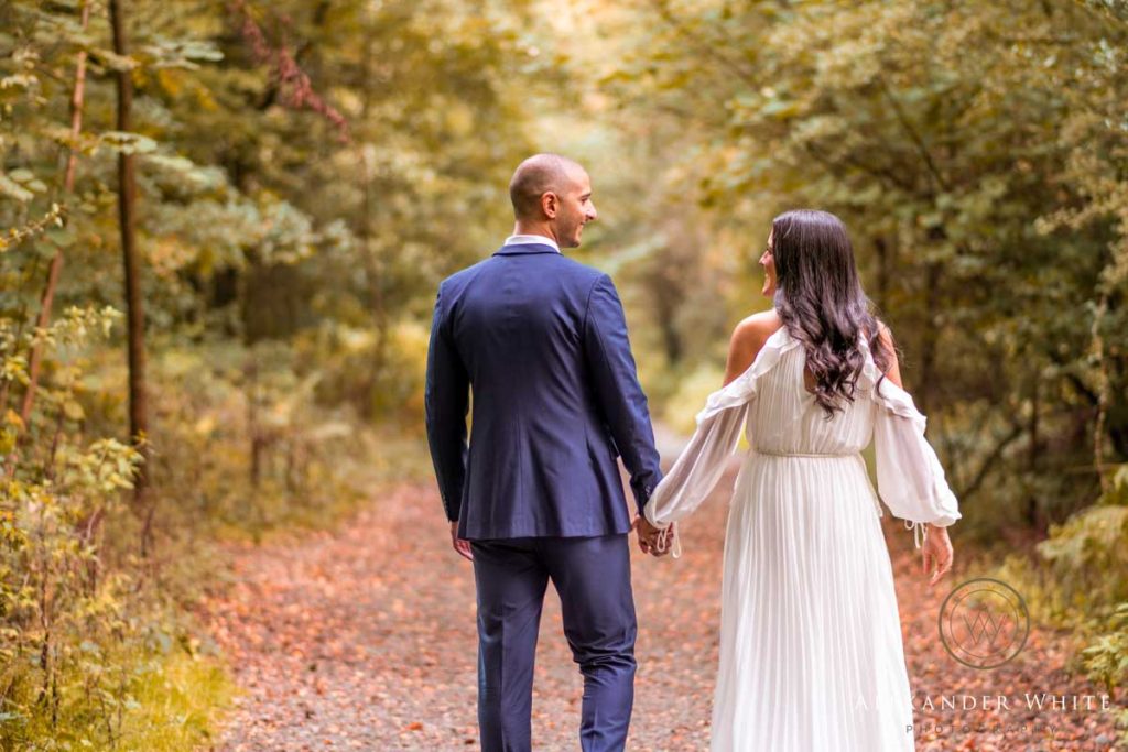 Couple walking away holding hands