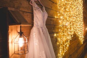 Wedding dress hanging in a barn