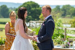 Bride and groom saying their vows at an outdoor wedding