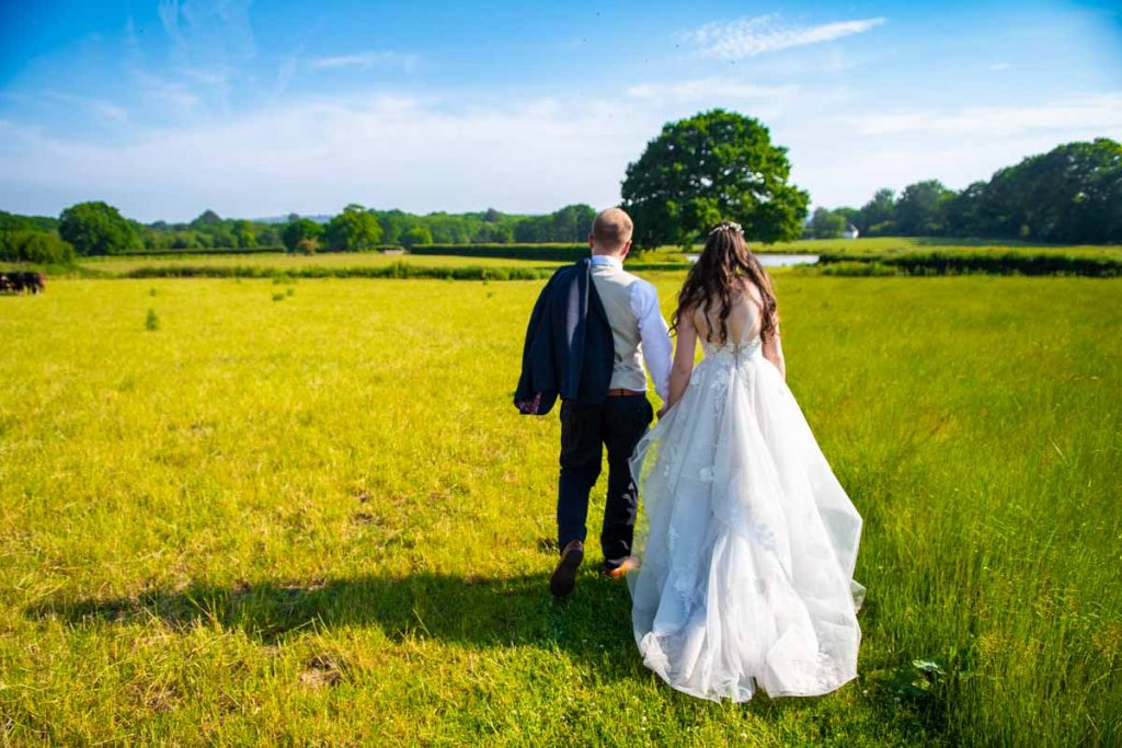 Bride and groom wedding photos in a field at Southlands Barn