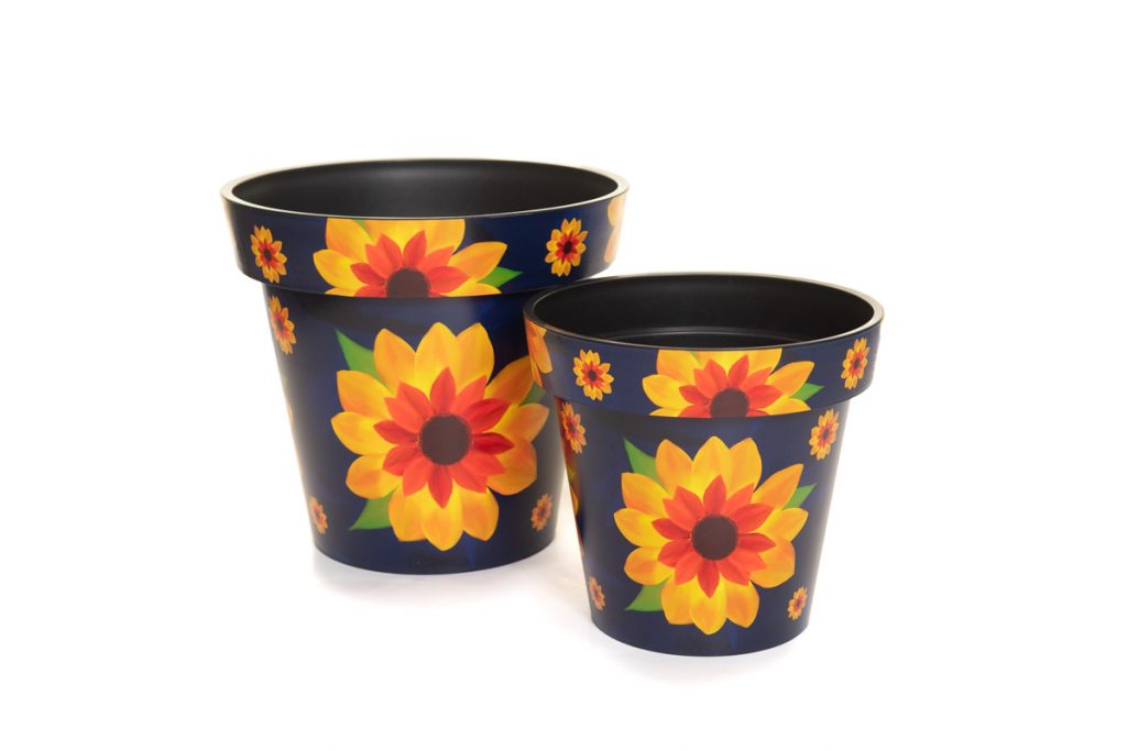 Two plant pots with sunflowers painted on photographed for a catalogue