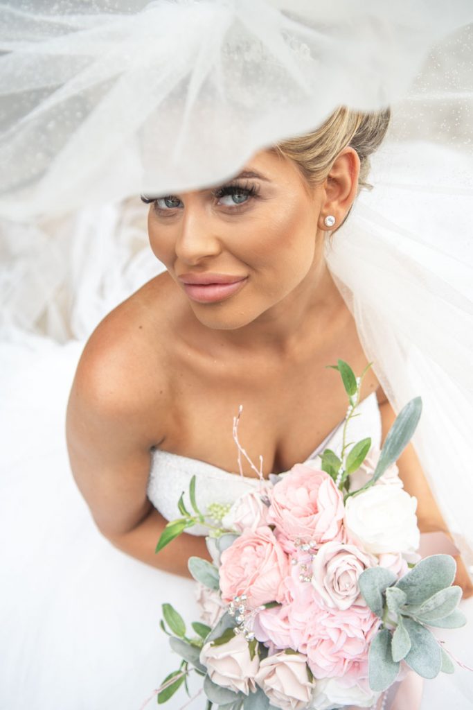 A magazine style image of a bride taken from under the bride's veil