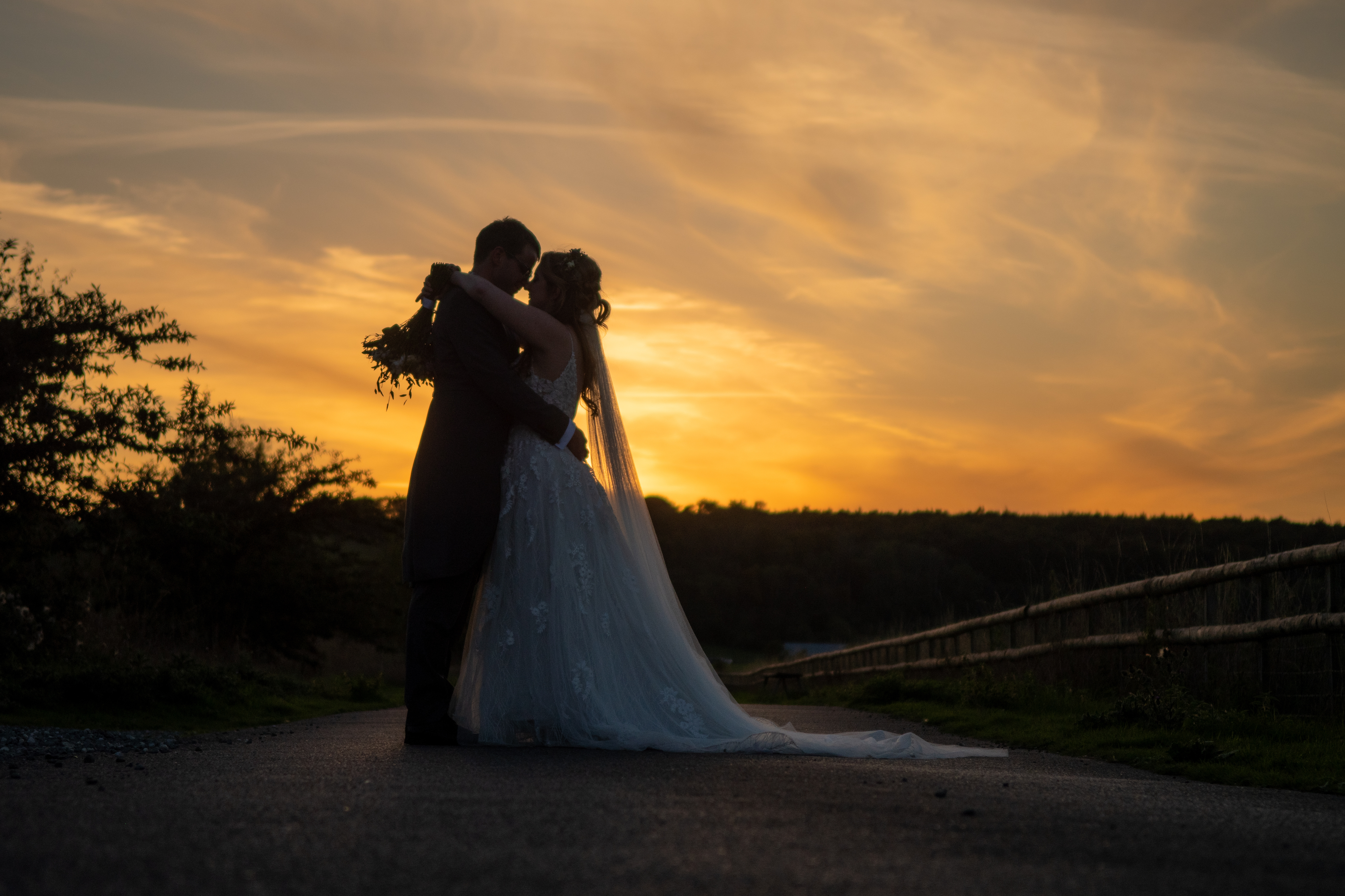 Couple silhouetted by the sunset at Long Furlong Barn