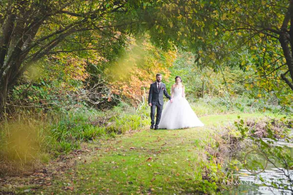Bride and groom walking in the grounds of the ravenswood hotel