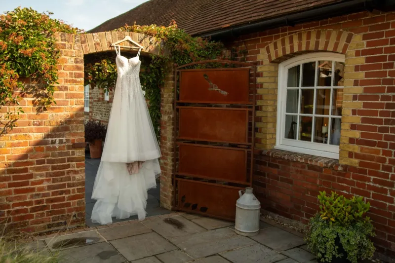 A wedding dress hanging up in an archway
