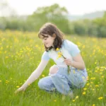 A teenage girl collects wildflowers