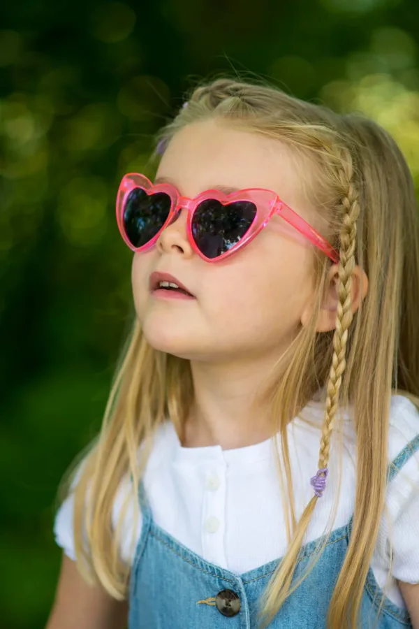 A portrait of a young girl in sunglasses