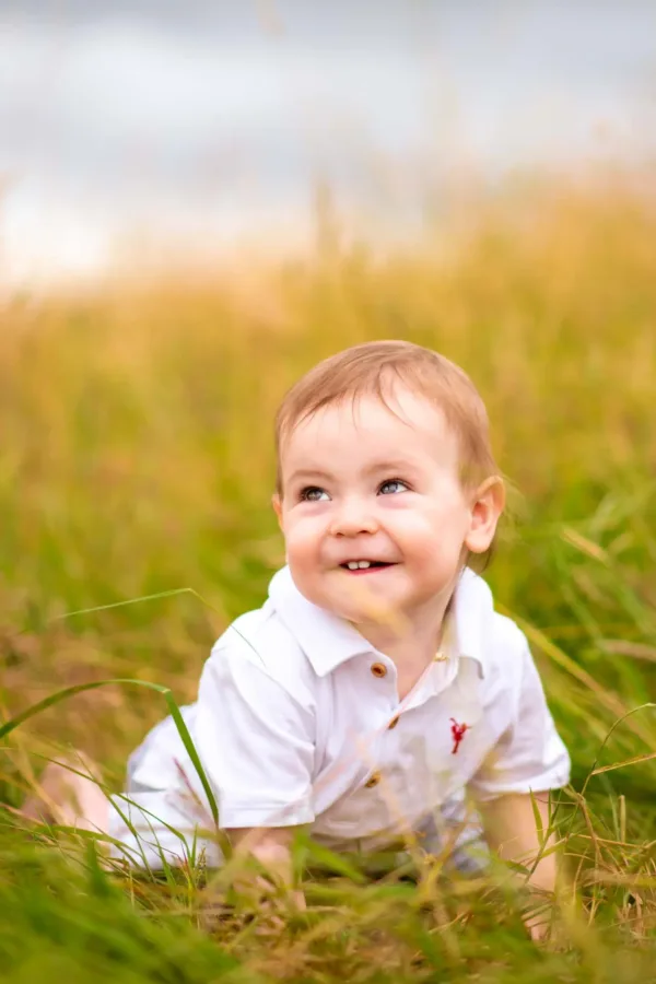 Young boy playing in long grass