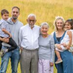 An extended family photo captured in a wild flower meadow