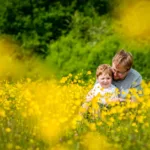 Father and son in a field full of flowers