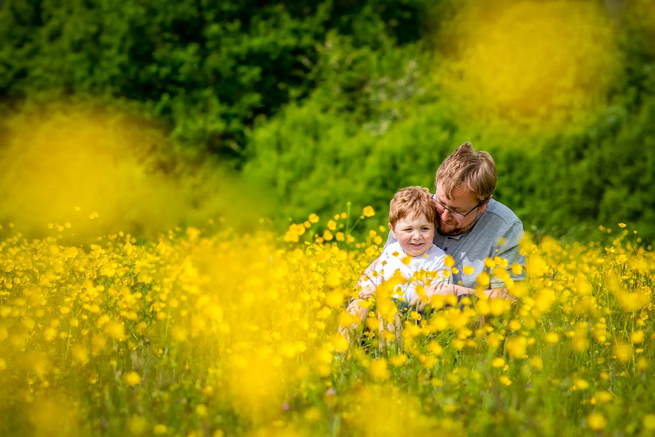 Father and son in a field full of flowers