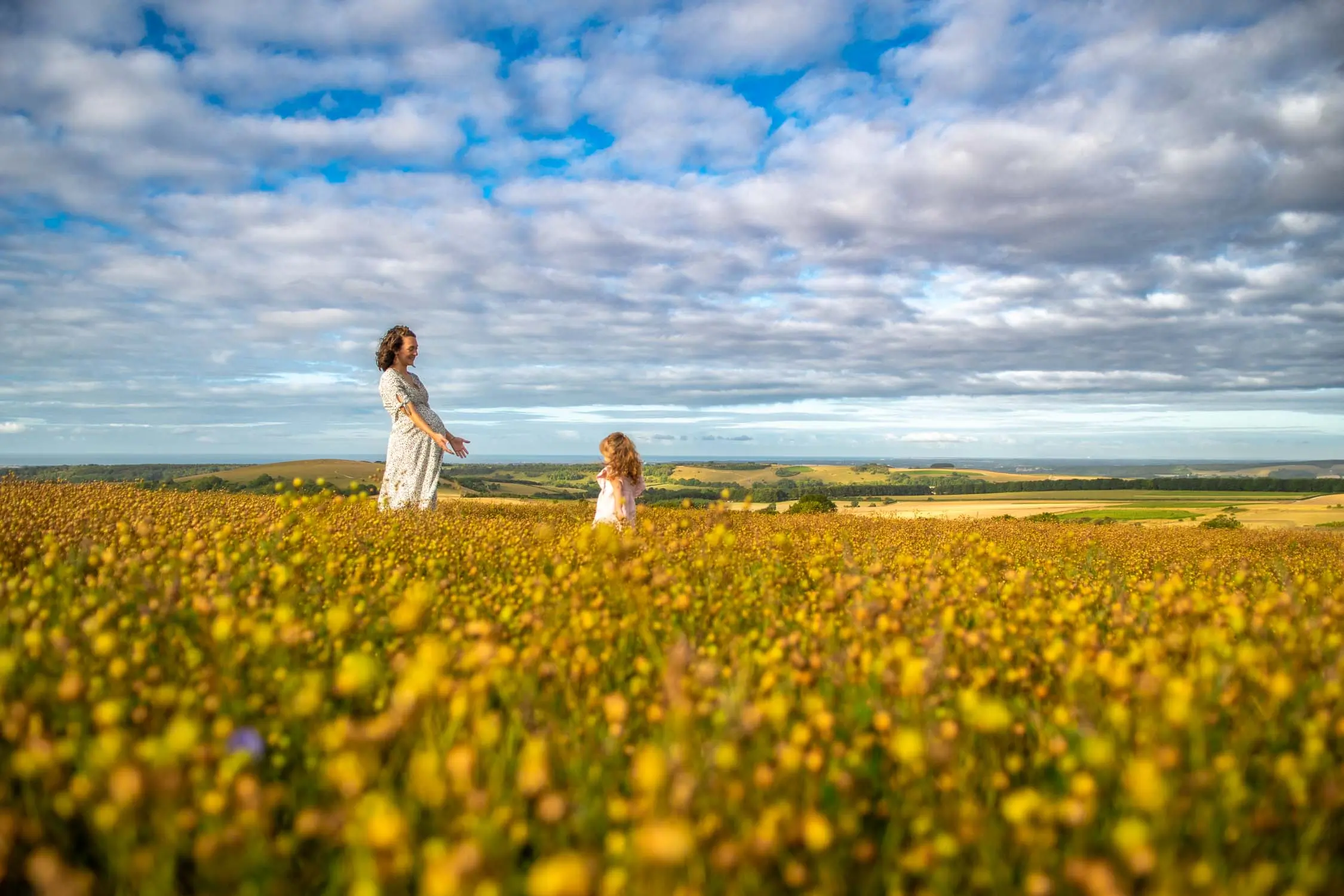 Mother and daughter in a field full of flowers