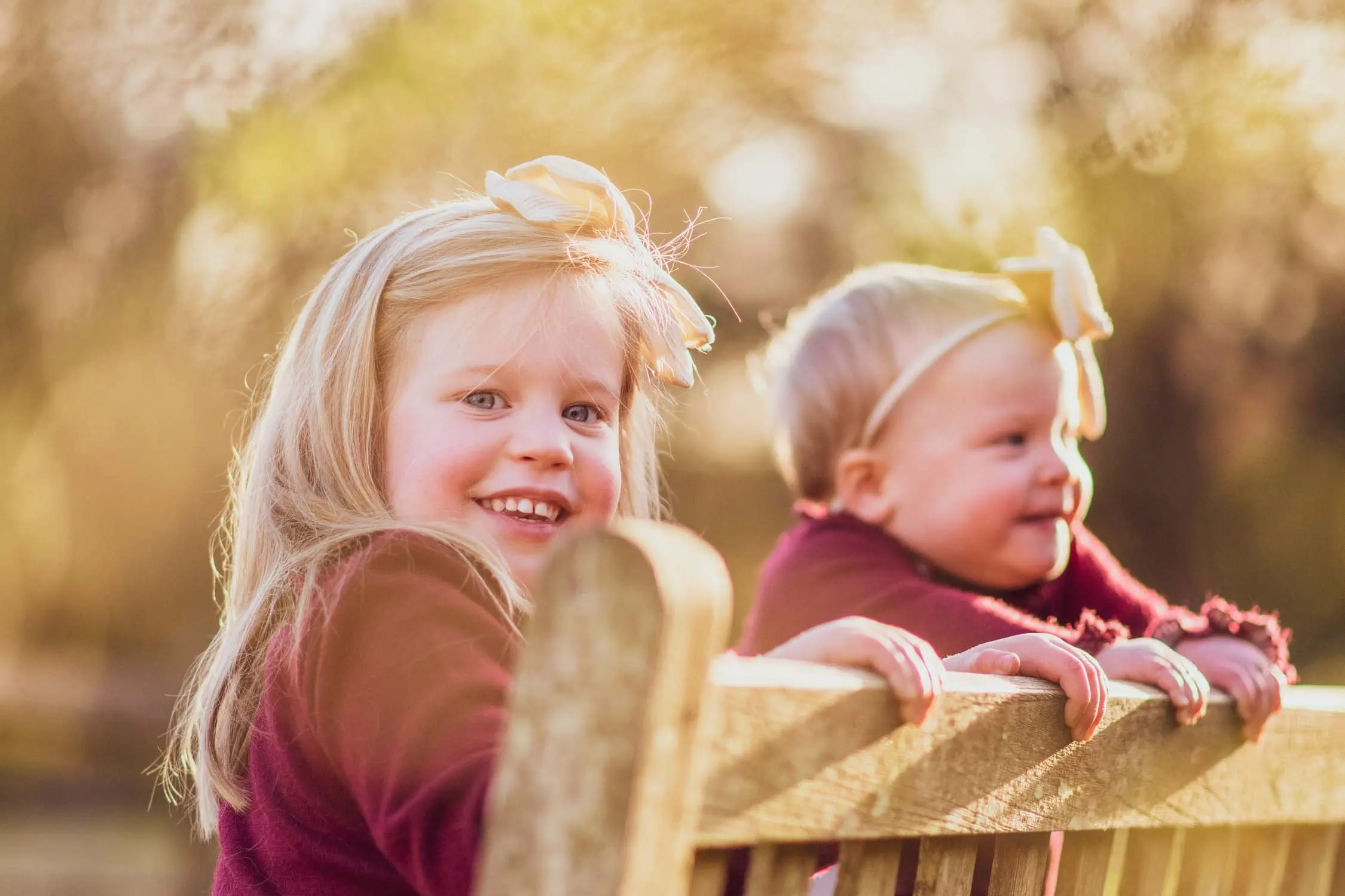 Young sisters sitting on a bench