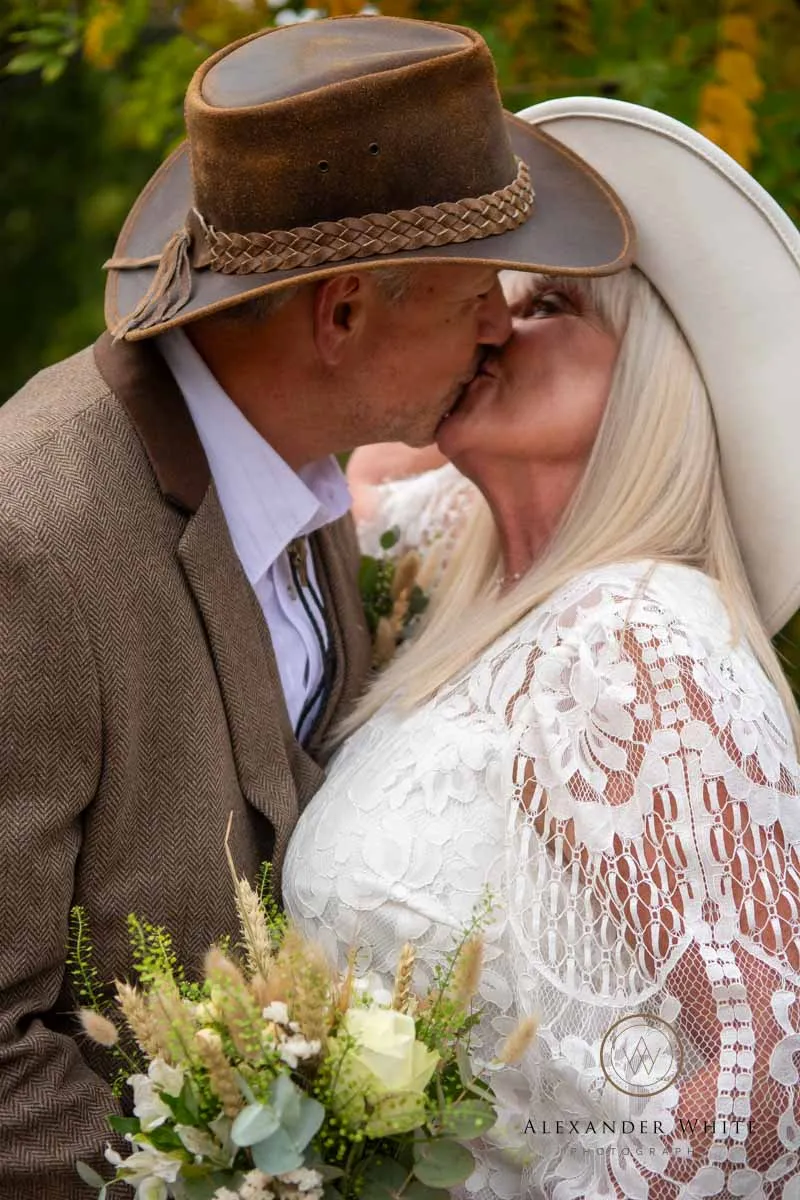 Newlywed Couple kissing - western themed wedding