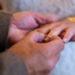 Wedding ring going onto bride's finger at western themed wedding