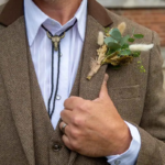Groom outfit details at western themed wedding