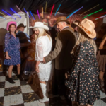 Bride and groom line dancing at western themed wedding