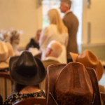 wedding guests wearing cowboy hats at a western themed wedding